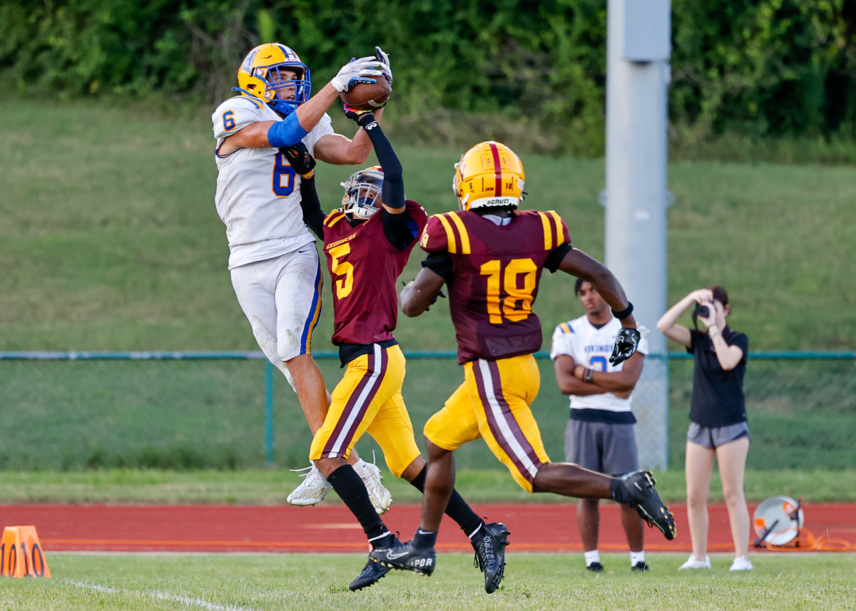 Jude James leaps for a touchdown reception against Lutheran North.