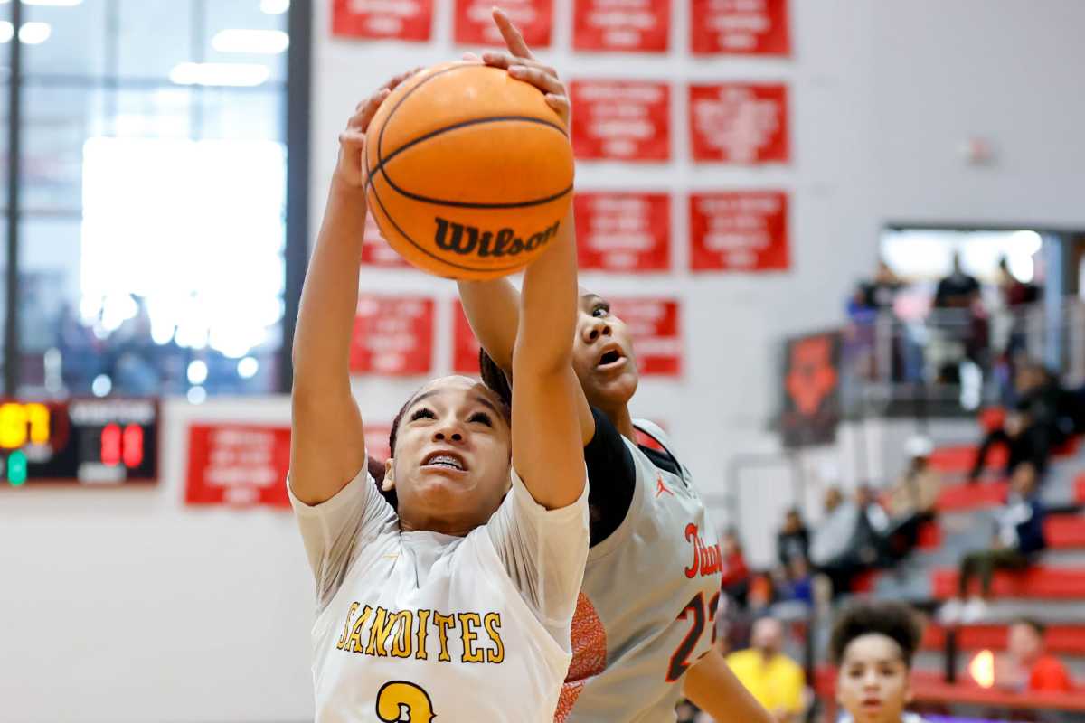 Sand Springs' Taiona Morris (3) and Carl Albert's Audrey Plunkett (23) battle for a rebound.