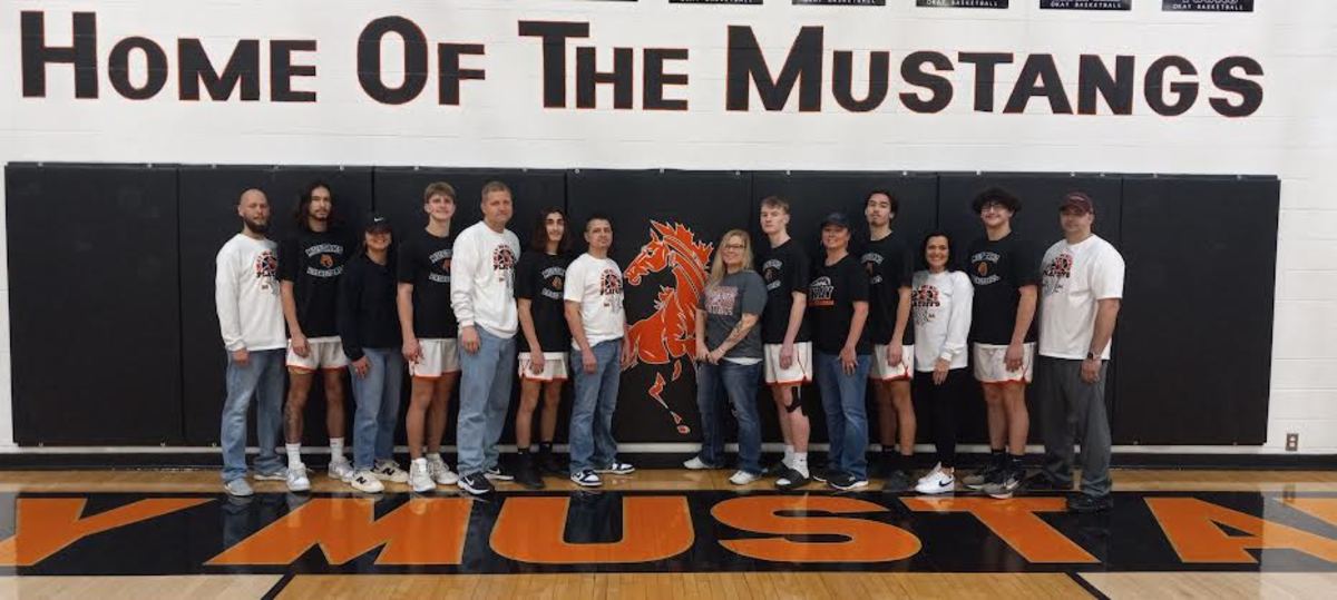 From left, Okay’s Duckee Swimmer, flanked by stepdad Chris Young and mom Linzee Custer, Chase Clark and head coach Chad Clark, Diezel Davis and dad Nick Davis, Tabby Walters with her son Ashton, Tammy Ramos and her son Tito Ramos, and sandwiching their son Bryson Parnell are Vanessa Rowlands and Danny Parnell. All these parents of Okay’s state tournament team were former Mustangs themselves.