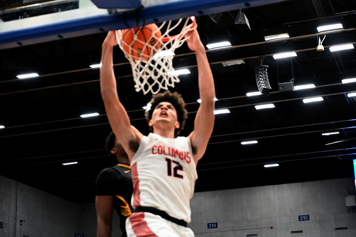 Cameron Boozer (12) from Miami Columbus dunks the ball to tie the game at the buzzer and send the FHSAA Class 7A state title game into overtime on Saturday at the RP Funding Center in Lakeland.