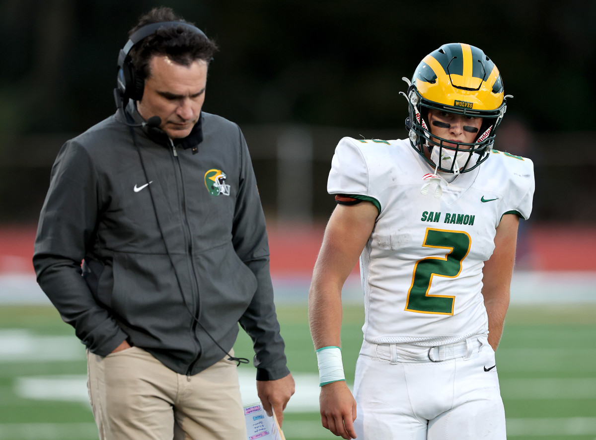 Luke Baker (2) talking things over with head coach Aaron Becker 