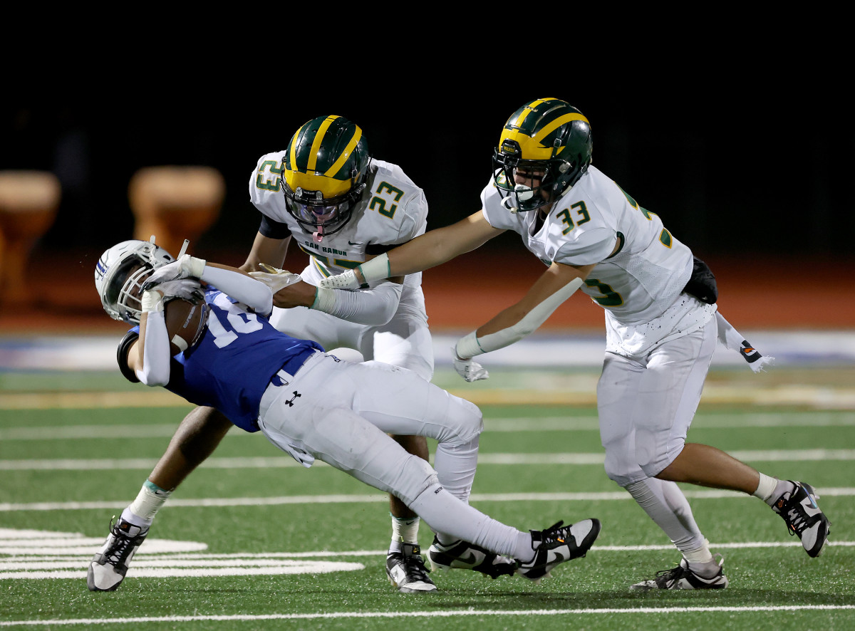 Niko White (18) comes down with a catch for Acalanes