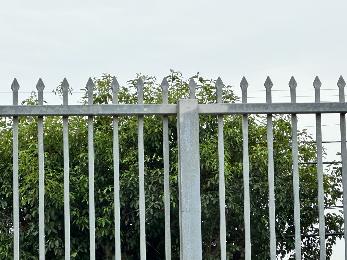 The Dymally High football stadium is surrounded with a steel fence with sharp, pointed tops.