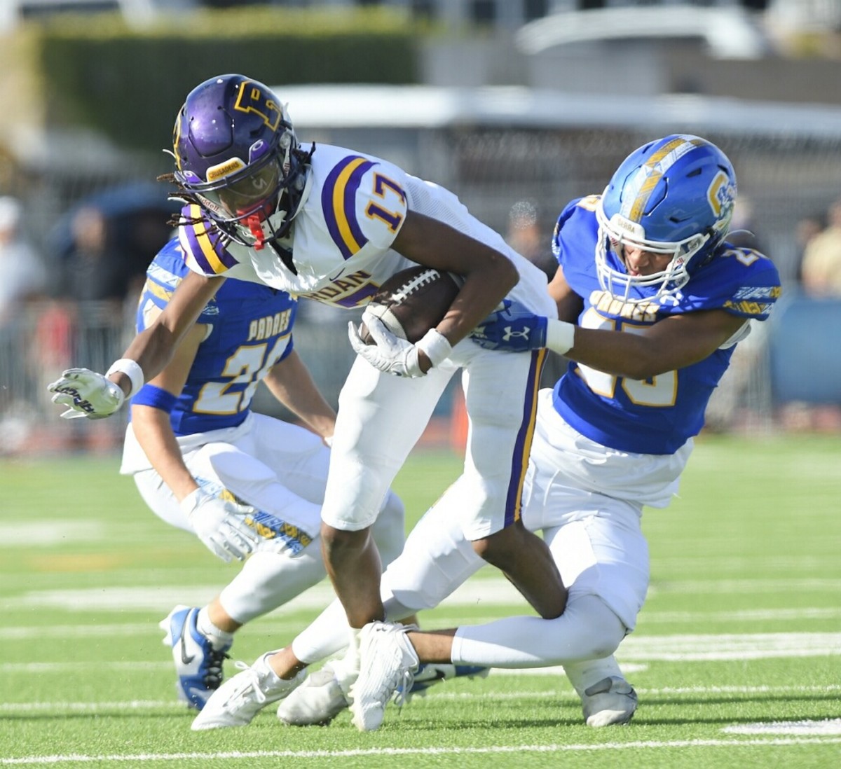 Riordan sophomore receiver Cynai Thomas (17) is corralled in the Serra secondary