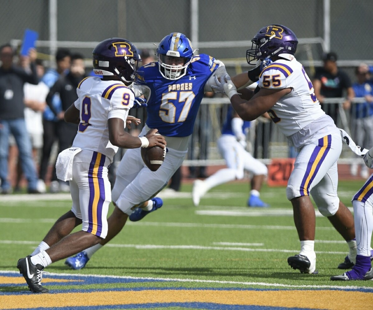 Serra junior defensive end Tommy Miller (57) takes b-line toward Riordan freshman quarterback Michael Mitchell Jr.