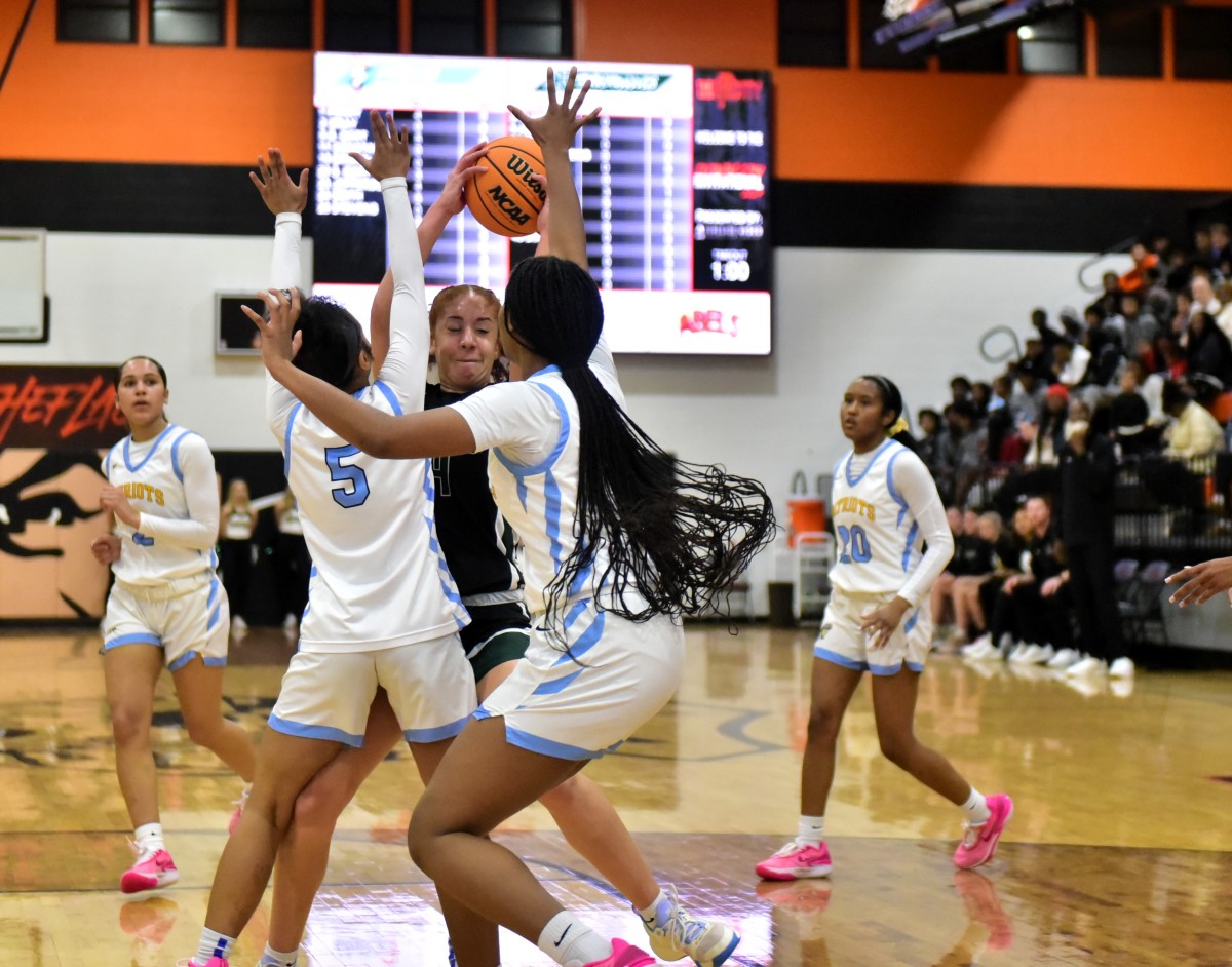 Putnam City West players (in white) heavily guard a Norman North player during the Putnam City Invitational on Jan. 6, 2023.