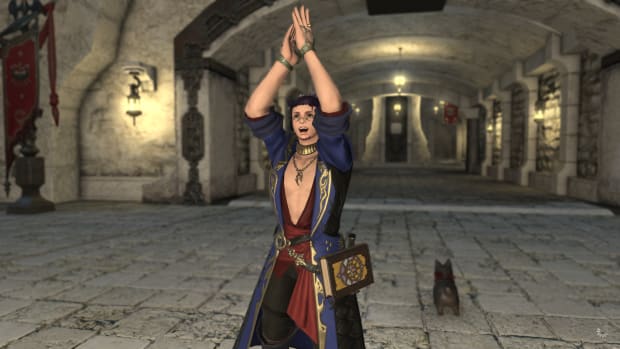 A Final Fantasy 14 Miqo'te wearing a blue robe with gilded stream and a red sash is standing in front of a stone tunnel, clapping his hands