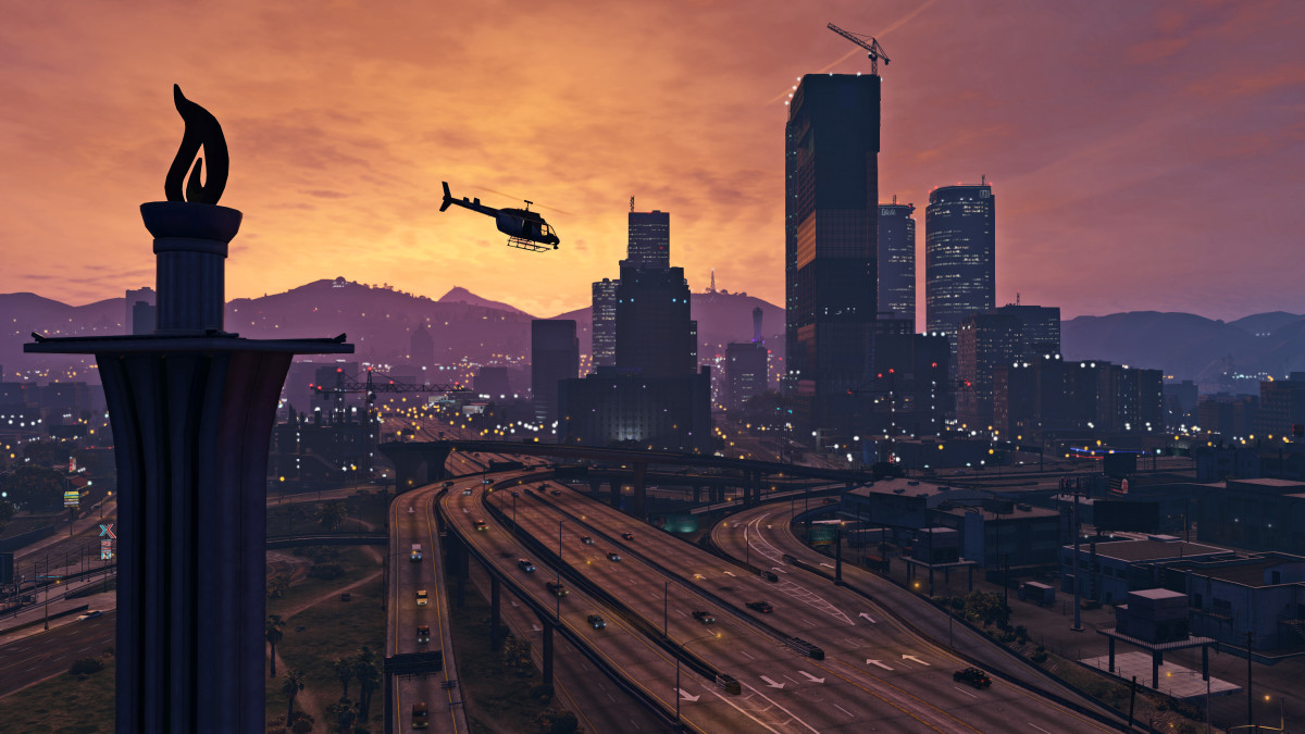 GTA 5 screenshot of downtown Los Santos at dusk as a helicopter flies overhead