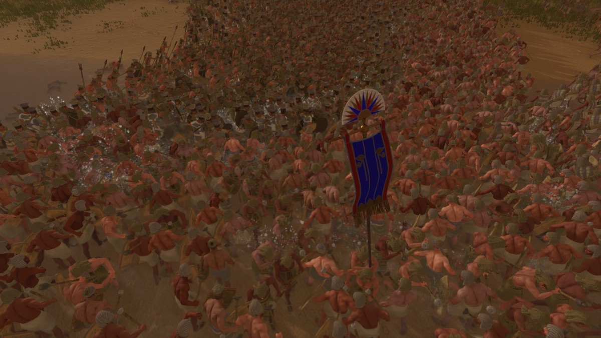 Total War: Pharaoh screenshot showing a chaotic melee in a river.